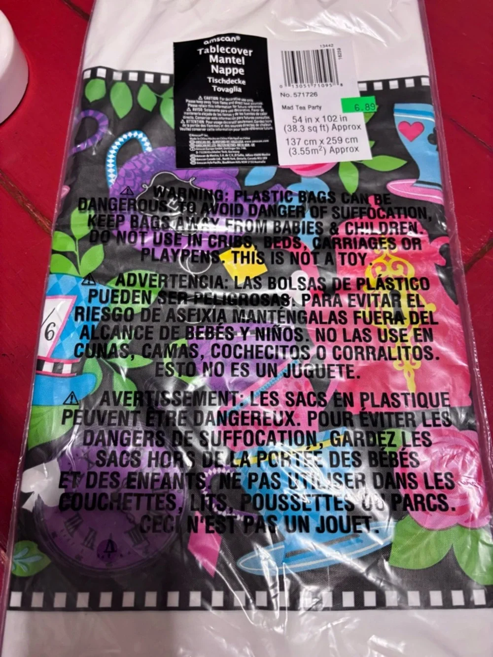 Alice in Wonderland plastic Tablecloth (NWT)and Queen of Hearts push button toy.